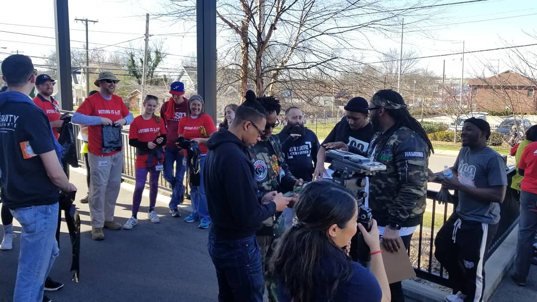 A group of volunteers, some in black shirts and some in red.